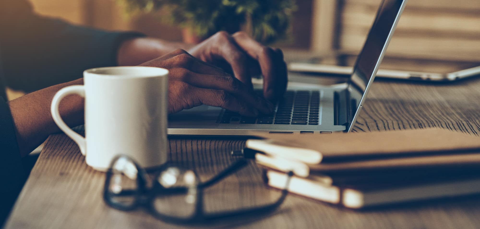 person working on a laptop with a coffee