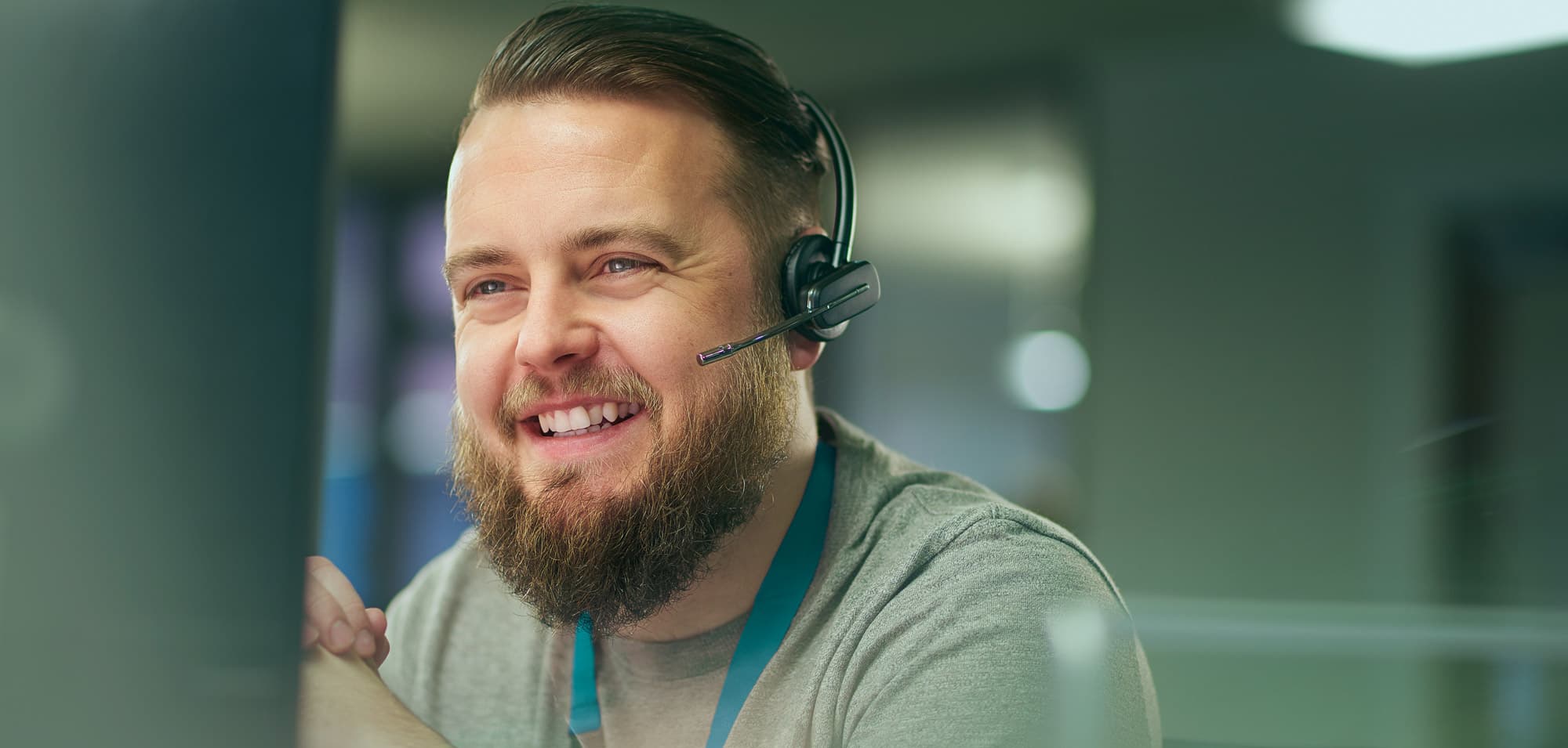 person smiling whilst taking a phone call