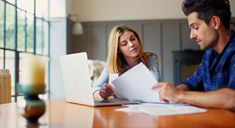 Couple looking at some paperwork.