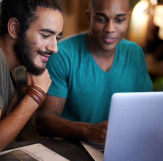 Two men looking at a laptop screen