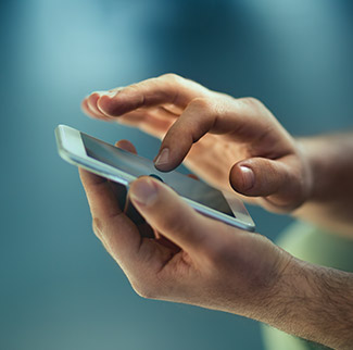 Woman in car looking at smartphone with MBNA on screen