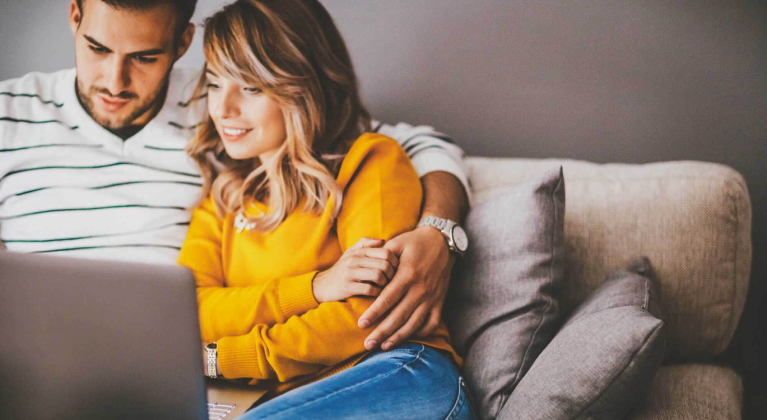 couple reading laptop