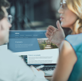 Man and lady looking at laptop
