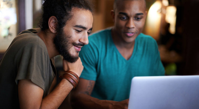 Two people looking at payment options on their laptop
