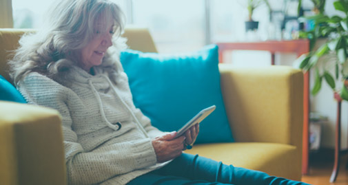 Woman on sofa looking at tablet