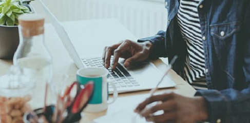 Woman sat at her desk on her laptop