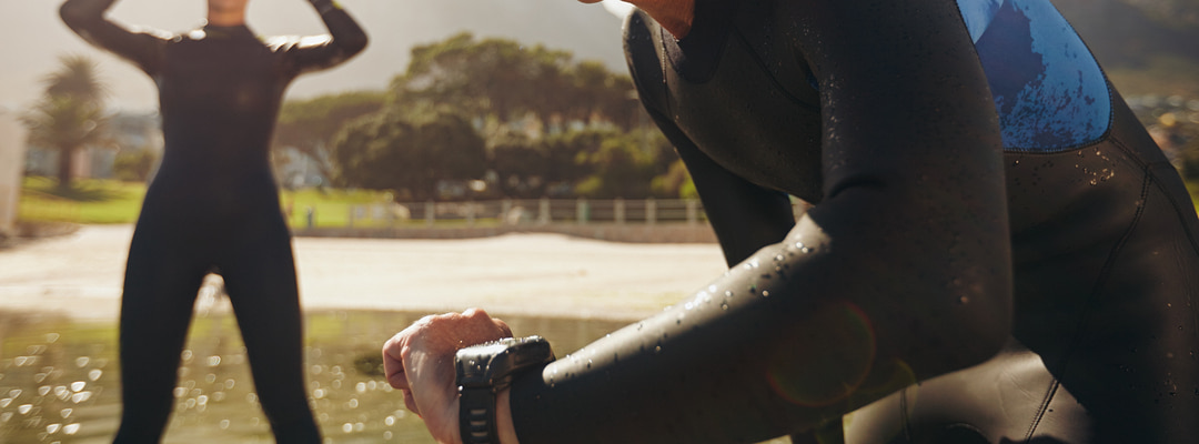 Two people wearing wetsuits