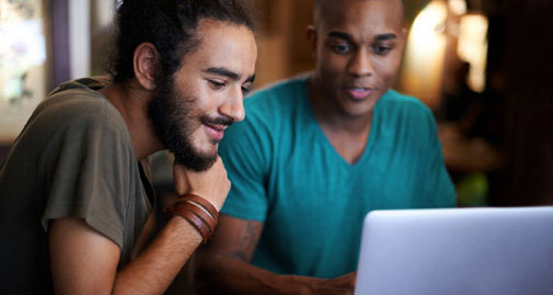 Two men looking at a laptop screen