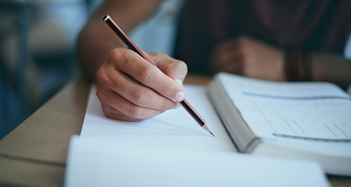 Person writing at a table