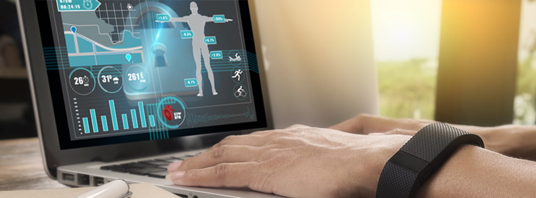 Person using a laptop, wearing a SmartBand