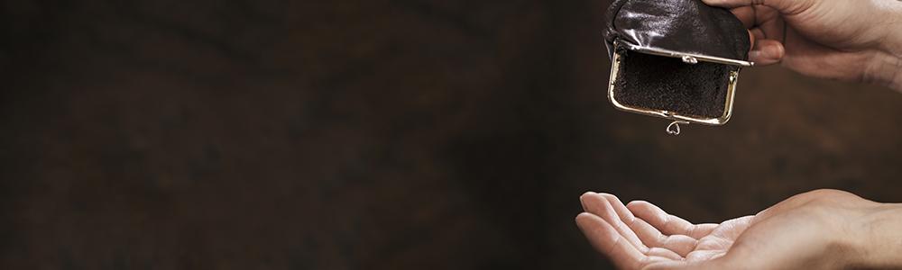 Woman's hands shaking empty purse