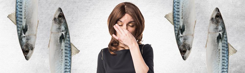 Woman holding nose at mackerel