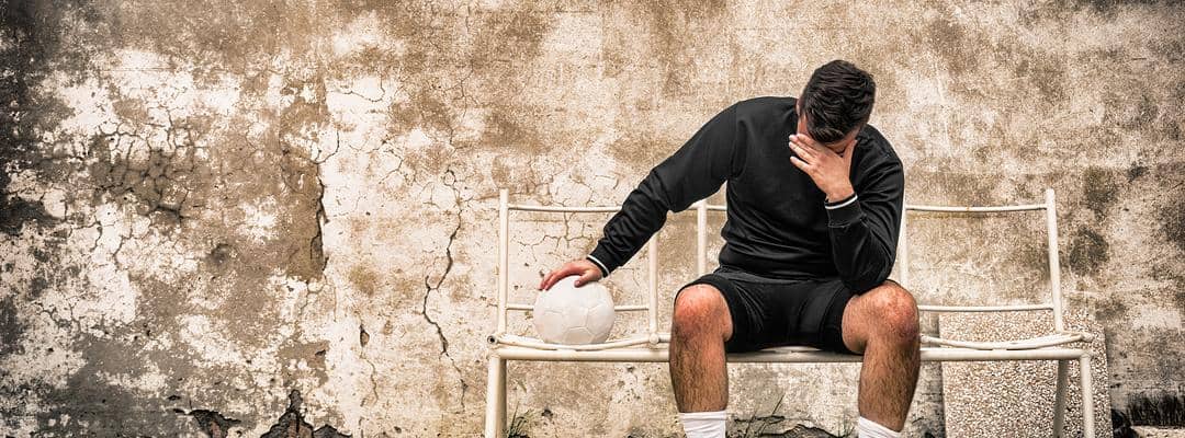 Football player with head in hand