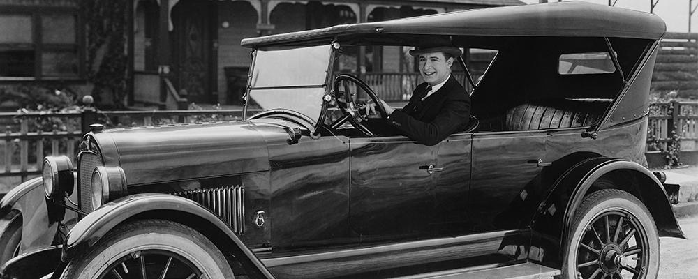 1940's man driving a vintage car