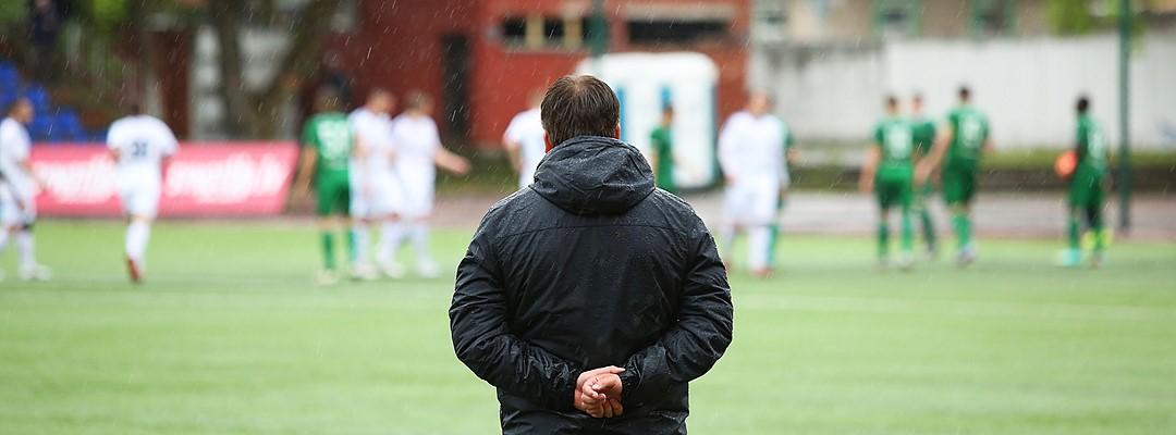 Football coach on football pitch