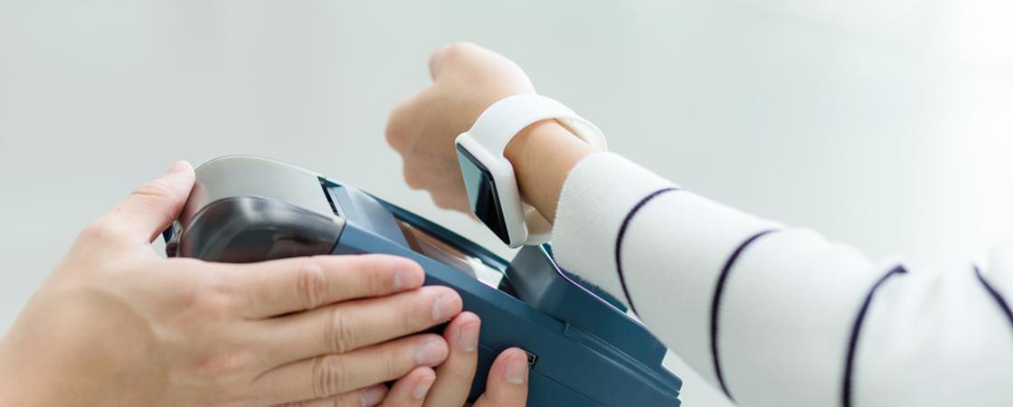 Person paying for something with smartwatch